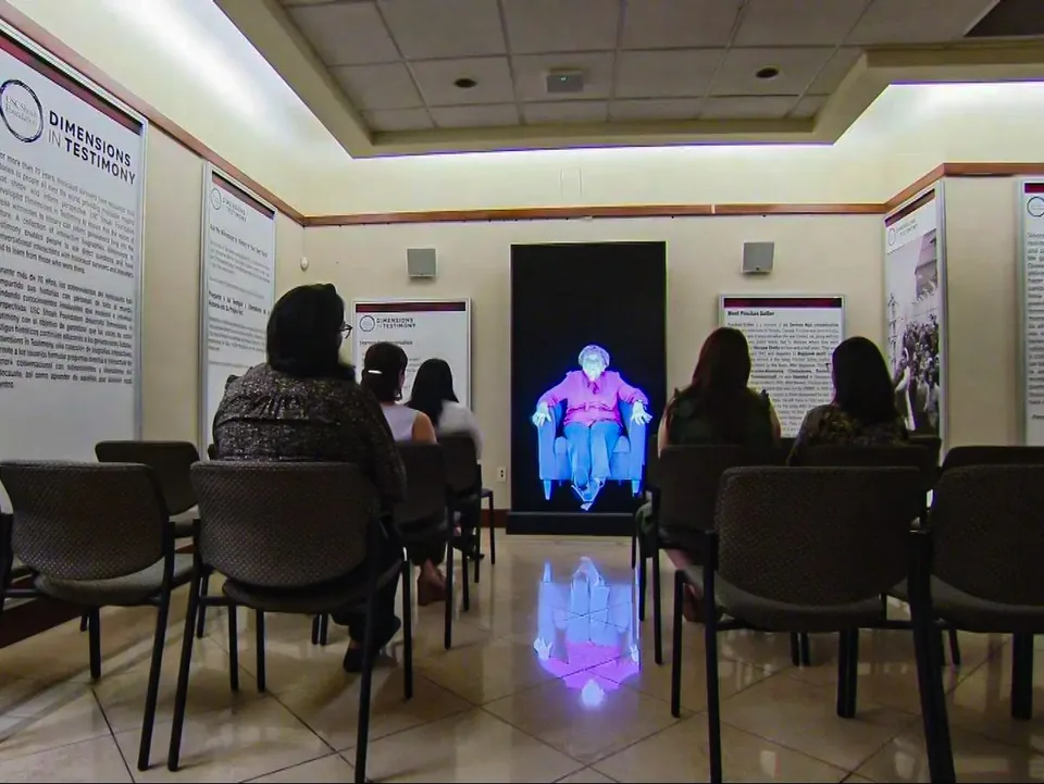 Visitors seated in the Dimensions in Testimony presentation room at El Paso Holocaust Museum