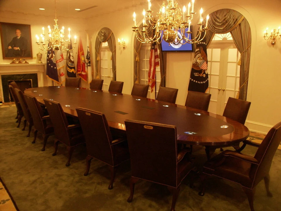 Interactive Cabinet Room exhibit at the Gerald R. Ford Presidential Museum, with a shared table and overhead audiovisual display