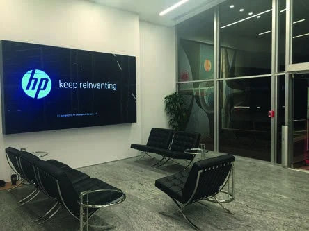 HP-branded video wall above seating in the HP Inc. lobby