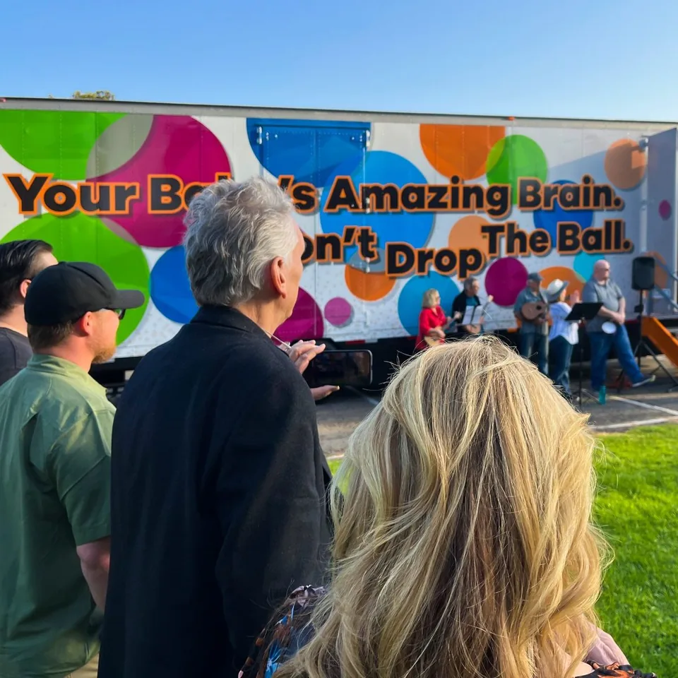 People gathered beside the Your Baby's Amazing Brain mobile exhibition