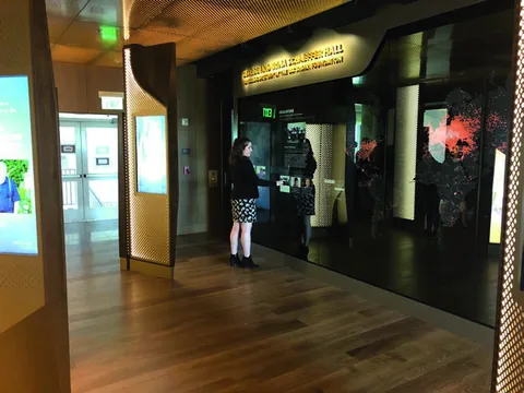 A visitor using the large interactive glass wall at USC Shoah Foundation’s headquarters